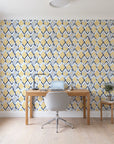 Gilded Crossing Navy chevron geometric wallpaper behind a modern oak desk in a bright home office