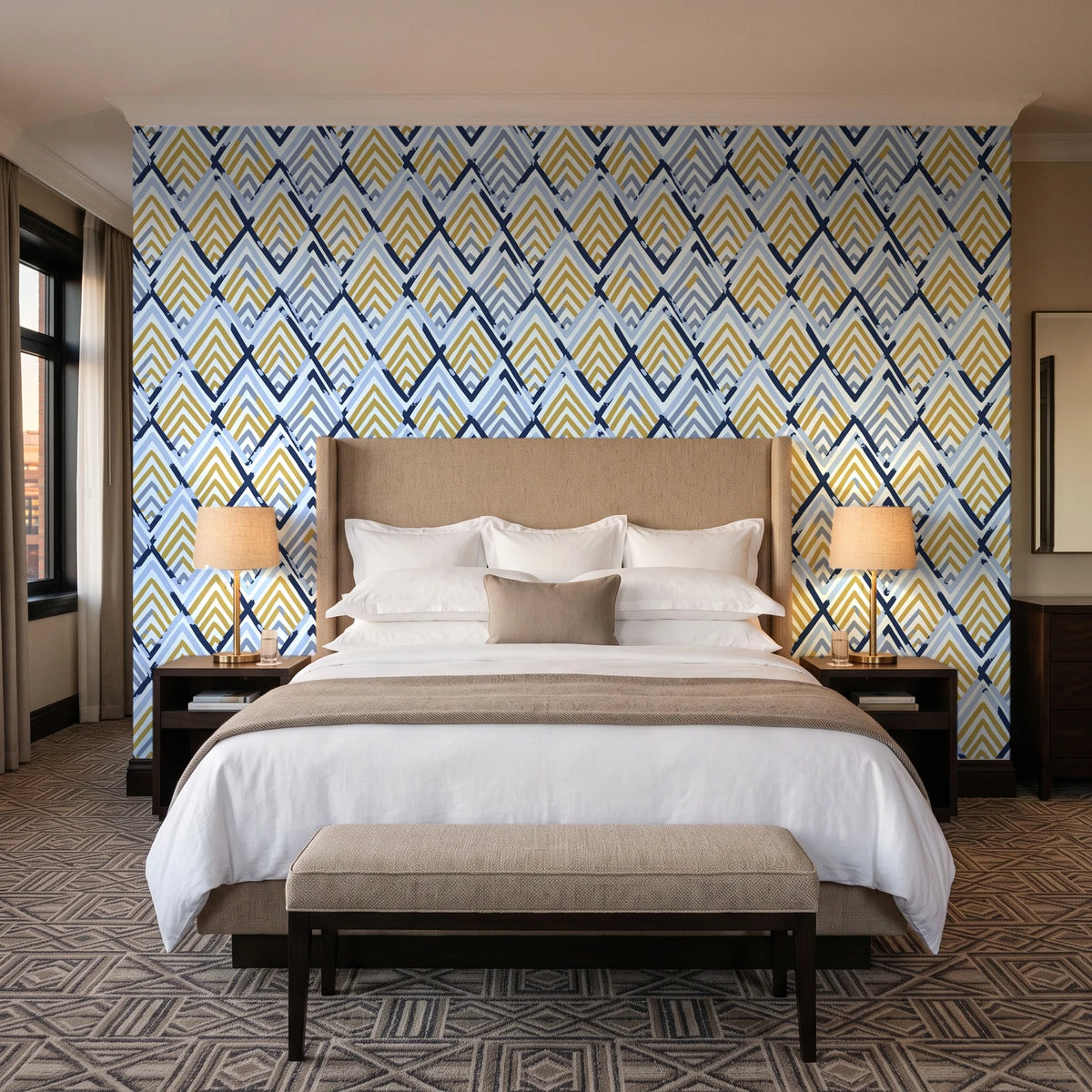 Gilded Crossing Navy chevron geometric wallpaper behind the headboard of a king bed in a contemporary hotel guest room