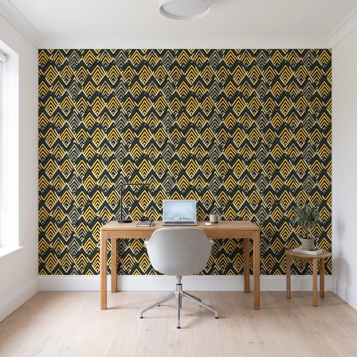 Gilded Crossing Onyx chevron geometric wallpaper behind a modern oak desk in a bright home office