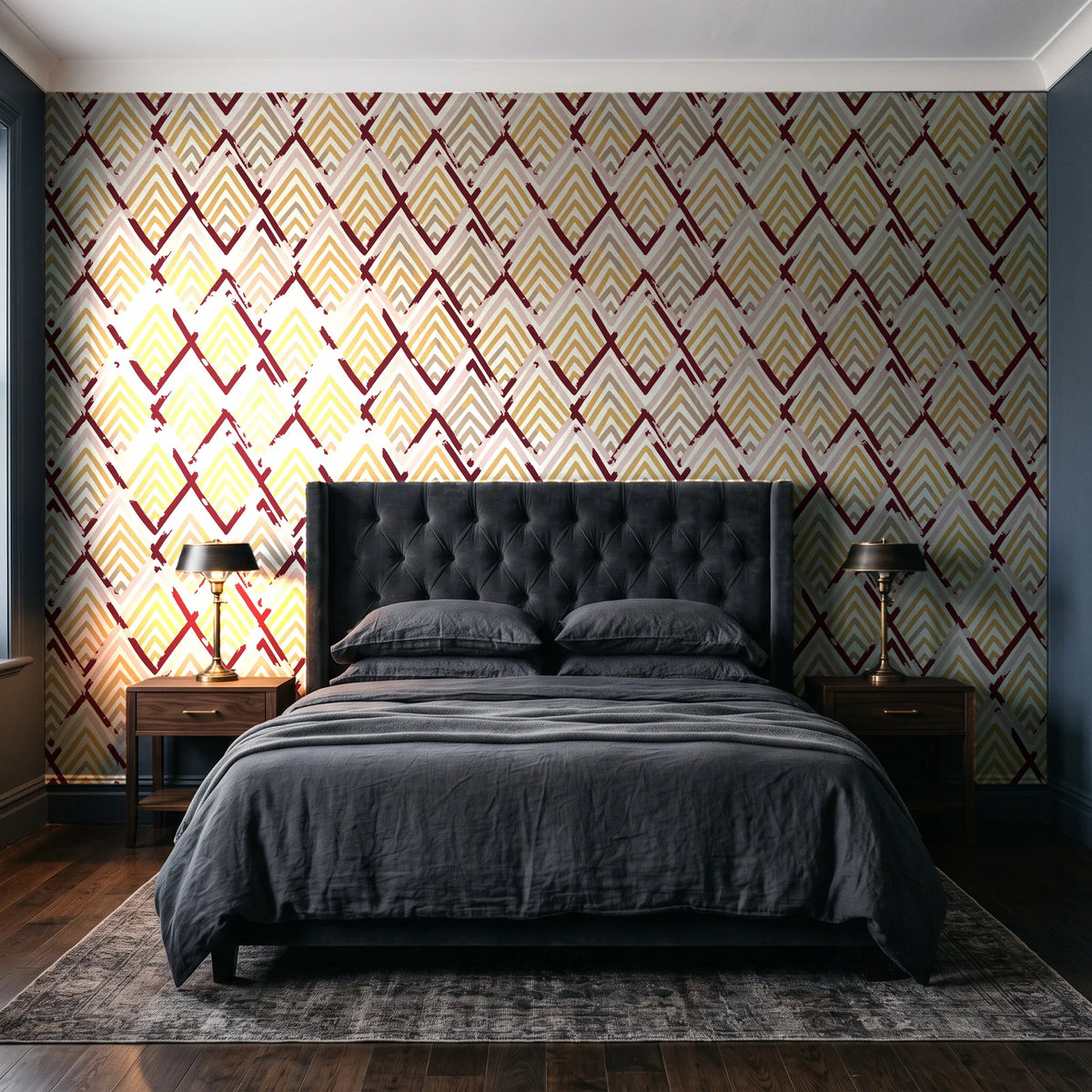 Gilded Crossing Oxblood chevron geometric wallpaper behind a tufted headboard in a dark, moody bedroom