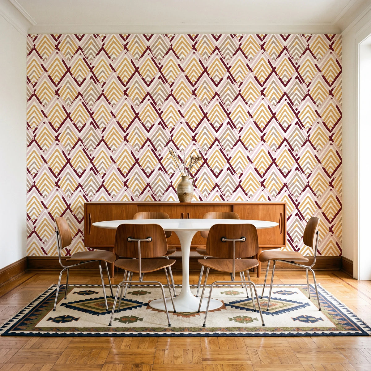 Gilded Crossing Oxblood chevron geometric wallpaper in a mid-century dining room with a teak sideboard and tulip table
