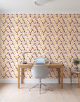 Gilded Crossing Oxblood chevron geometric wallpaper behind a modern oak desk in a bright home office