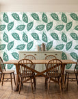 Gilded Frond Emerald leaf wallpaper in a farmhouse dining room with a sage sideboard and rustic trestle table