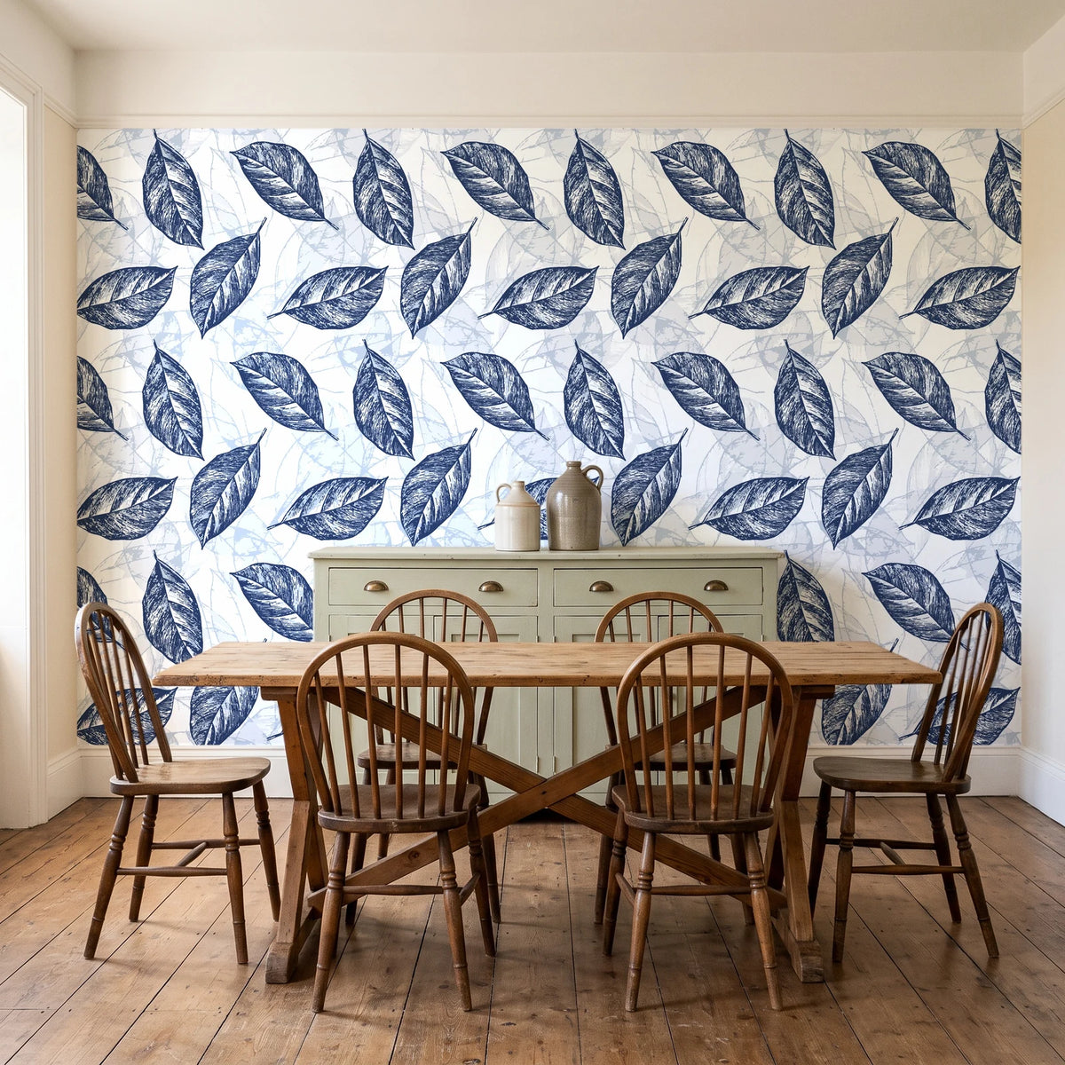 Gilded Frond Navy leaf wallpaper in a farmhouse dining room with a sage sideboard and rustic trestle table