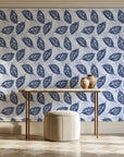 Gilded Frond Navy leaf wallpaper on the wall of a grand entry foyer