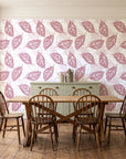 Gilded Frond Rose leaf wallpaper in a farmhouse dining room with a sage sideboard and rustic trestle table
