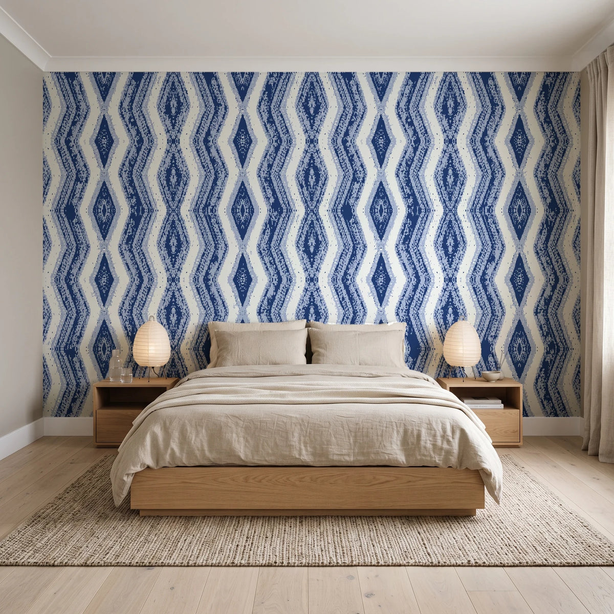 Gilded Rain Indigo geometric wallpaper behind a low platform bed in a serene Japandi bedroom