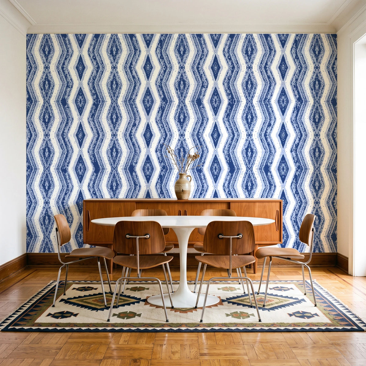 Gilded Rain Indigo geometric wallpaper in a mid-century dining room with a teak sideboard and tulip table