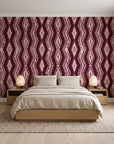 Gilded Rain Oxblood geometric wallpaper behind a low platform bed in a serene Japandi bedroom