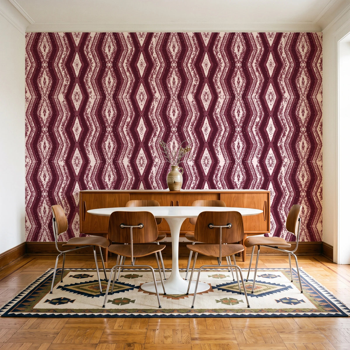 Gilded Rain Oxblood geometric wallpaper in a mid-century dining room with a teak sideboard and tulip table