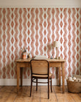 Gilded Rain Terracotta geometric wallpaper behind a vintage writing desk in a cozy craft-room home office