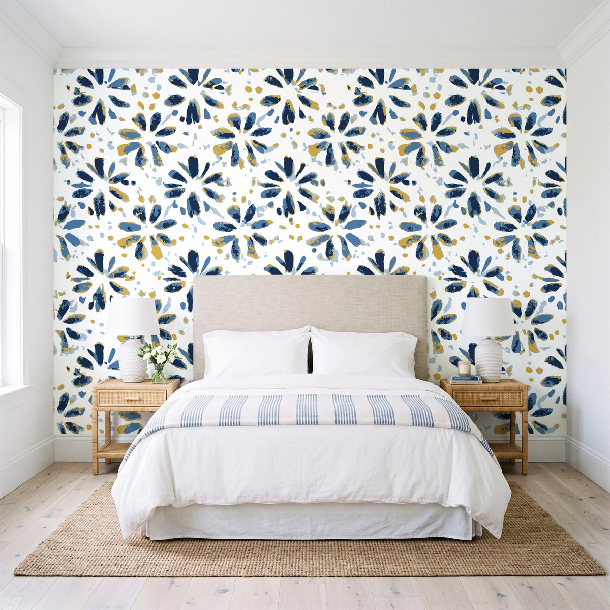 Gilt Scatter Navy floral scatter wallpaper behind a queen bed in a bright coastal bedroom