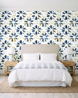 Gilt Scatter Navy floral scatter wallpaper behind a queen bed in a bright coastal bedroom