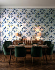 Gilt Scatter Navy floral scatter wallpaper in a dark moody dining room with a candlelit table
