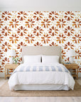 Gilt Scatter Terracotta floral scatter wallpaper behind a queen bed in a bright coastal bedroom