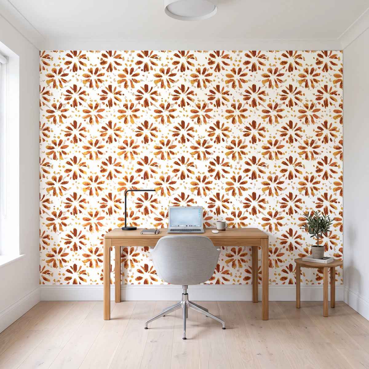 Gilt Scatter Terracotta floral scatter wallpaper behind a modern oak desk in a bright home office