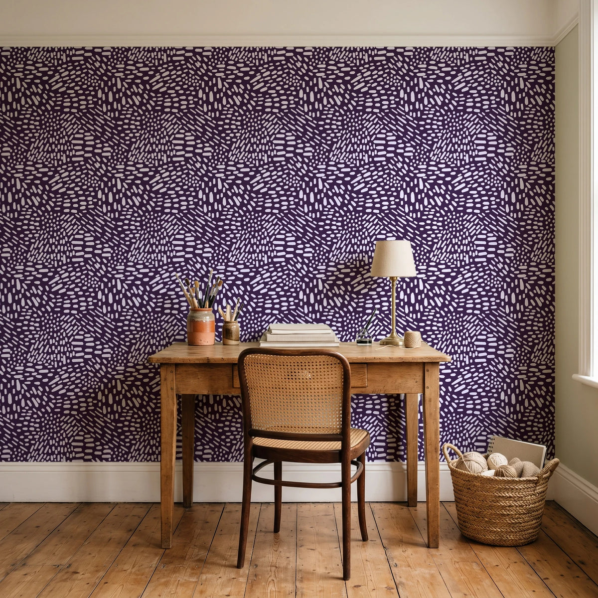 Grain Shift Aubergine minimalist dash wallpaper behind a vintage writing desk in a cozy craft-room home office