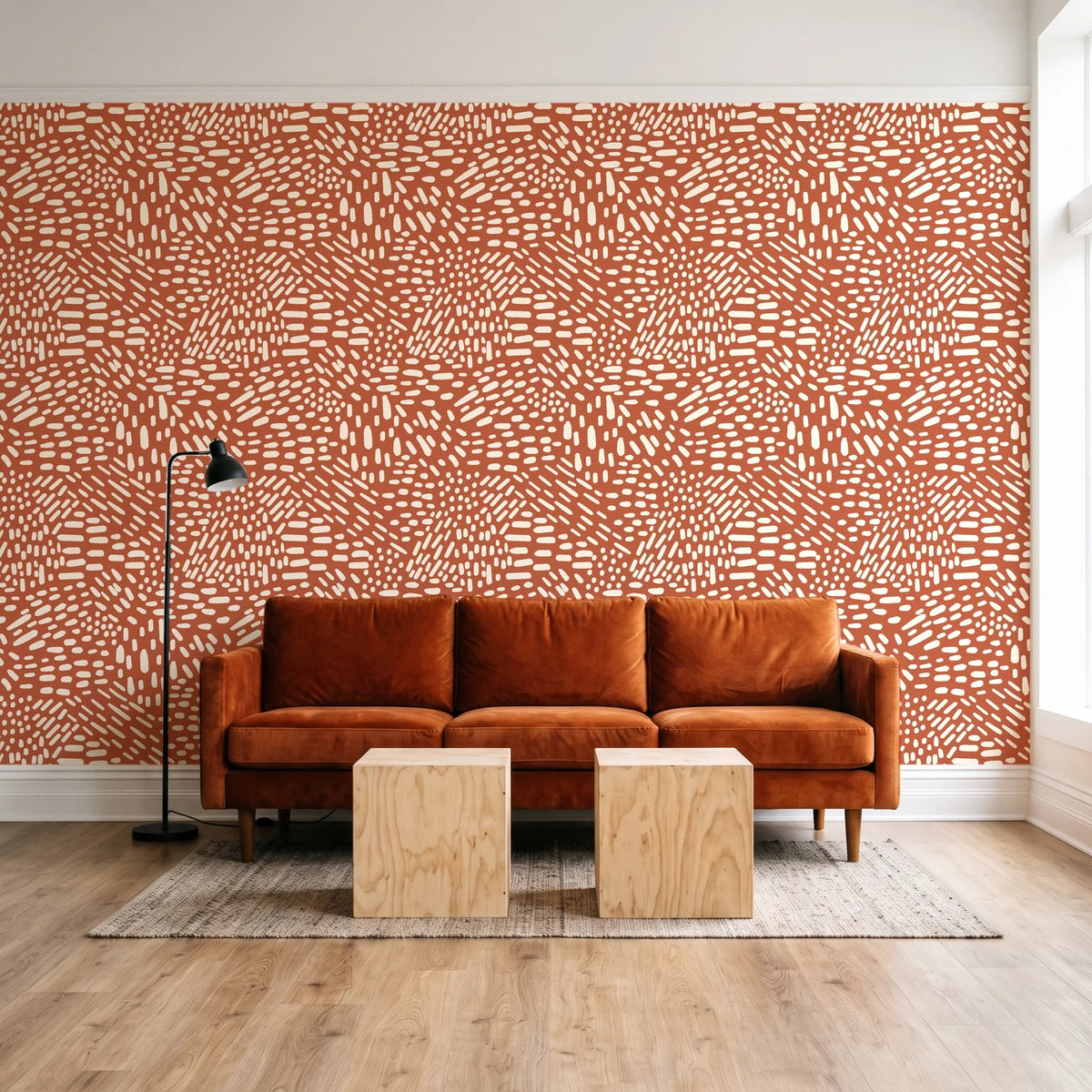 Grain Shift Terracotta minimalist dash wallpaper behind a rust velvet sofa in a bright coworking lounge