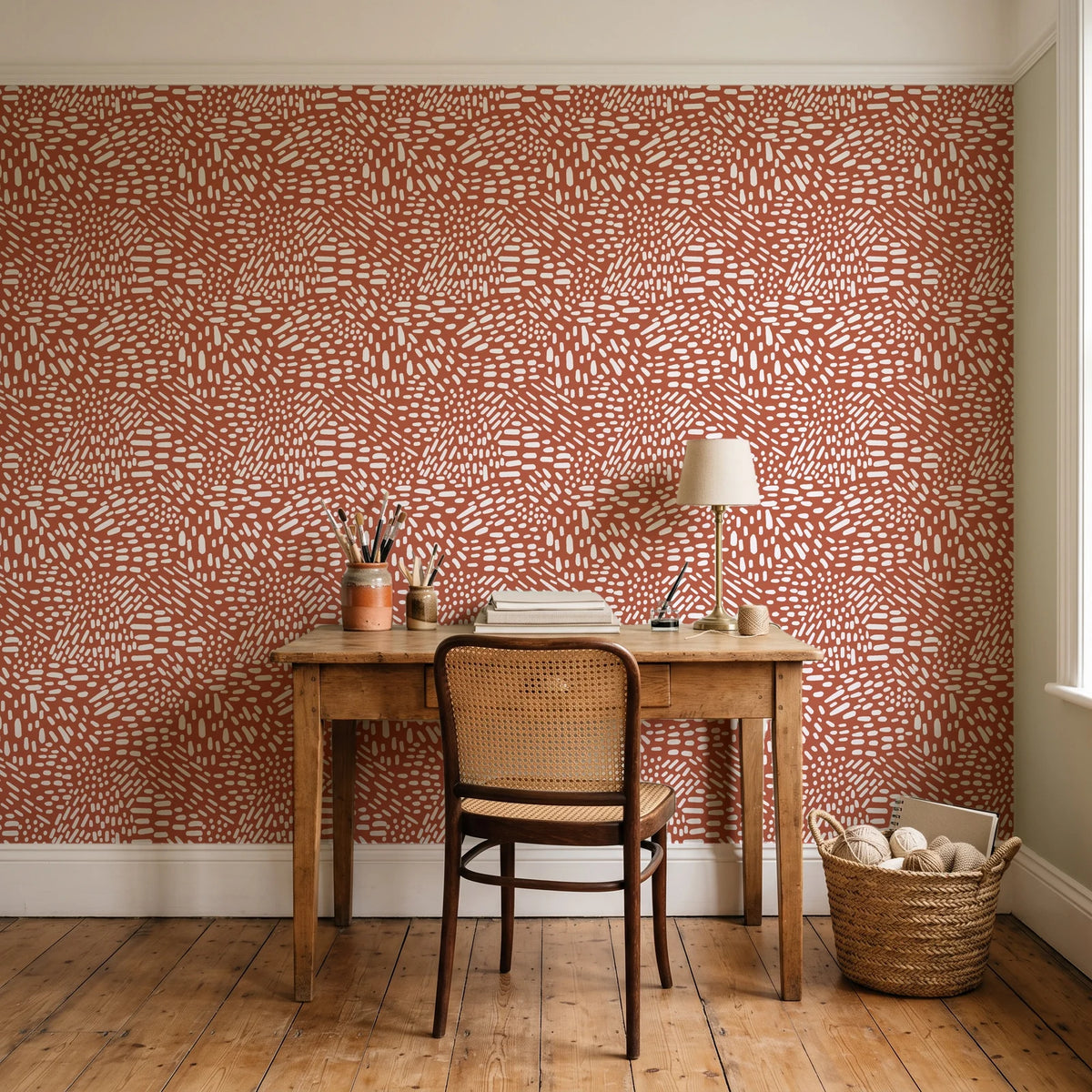 Grain Shift Terracotta minimalist dash wallpaper behind a vintage writing desk in a cozy craft-room home office