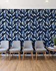 Hanging Garden Midnight botanical wallpaper behind a row of upholstered chairs in a bright clinic waiting room