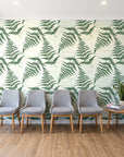 Harbor Fern Moss fern wallpaper behind a row of upholstered chairs in a bright clinic waiting room