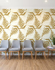 Harbor Fern Ochre fern wallpaper behind a row of upholstered chairs in a bright clinic waiting room