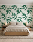 Harvest Crown Emerald leafy branch wallpaper behind a low platform bed in a serene Japandi bedroom