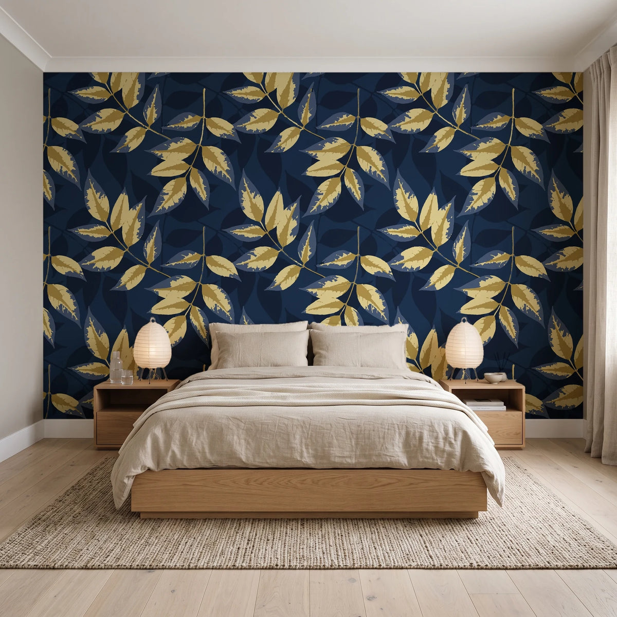 Harvest Crown Midnight leafy branch wallpaper behind a low platform bed in a serene Japandi bedroom