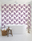 Harvest Crown Plum leafy branch wallpaper behind a freestanding tub in a bright coastal bathroom