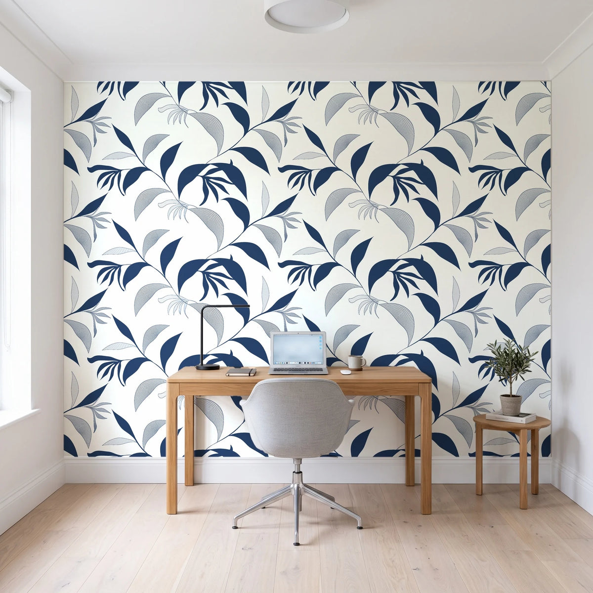 Hatched Frond Navy hatched frond wallpaper behind a modern oak desk in a bright home office