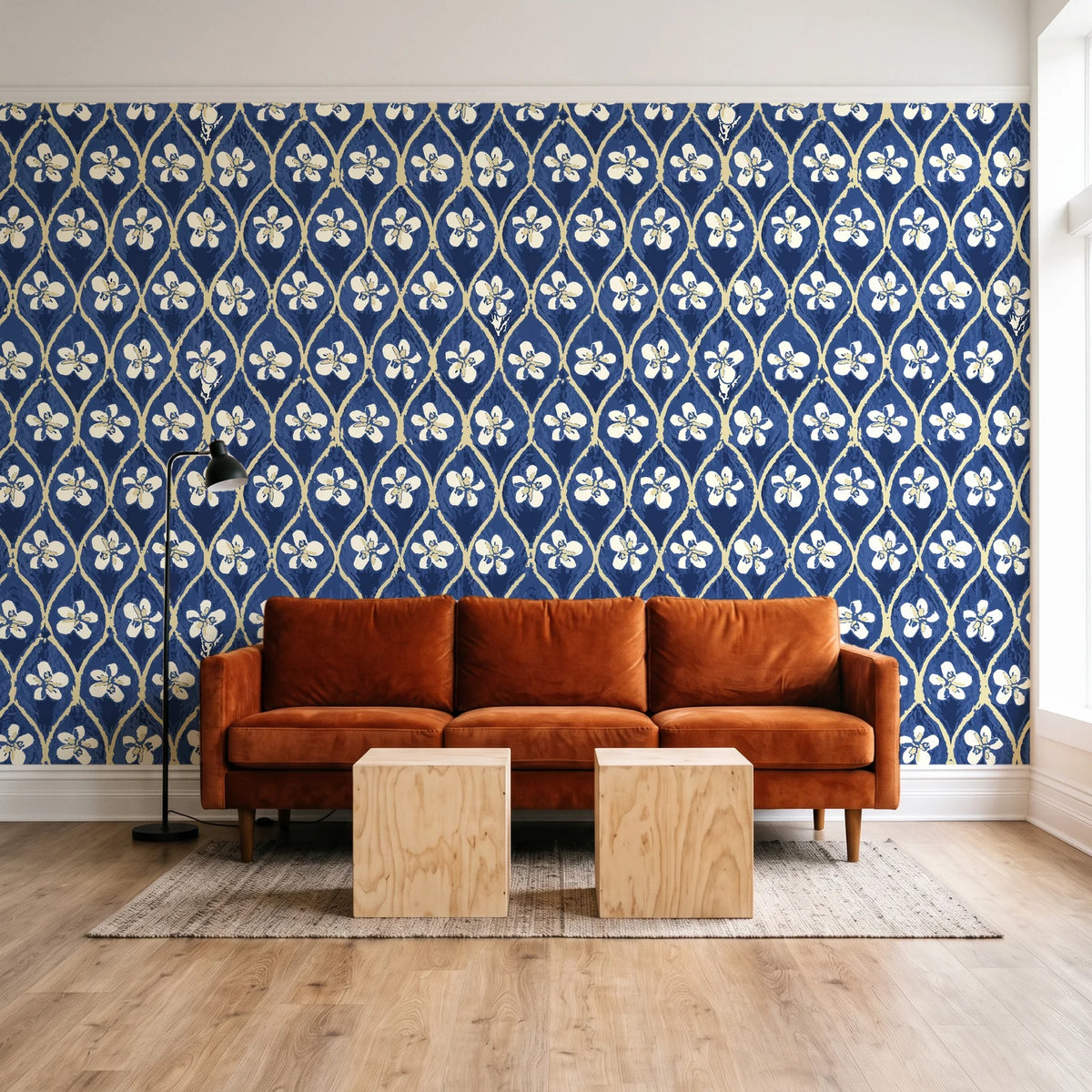 Hidden Court Midnight floral ogee wallpaper behind a rust velvet sofa in a bright coworking lounge