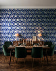 Hidden Court Midnight floral ogee wallpaper in a dark moody dining room with a candlelit table