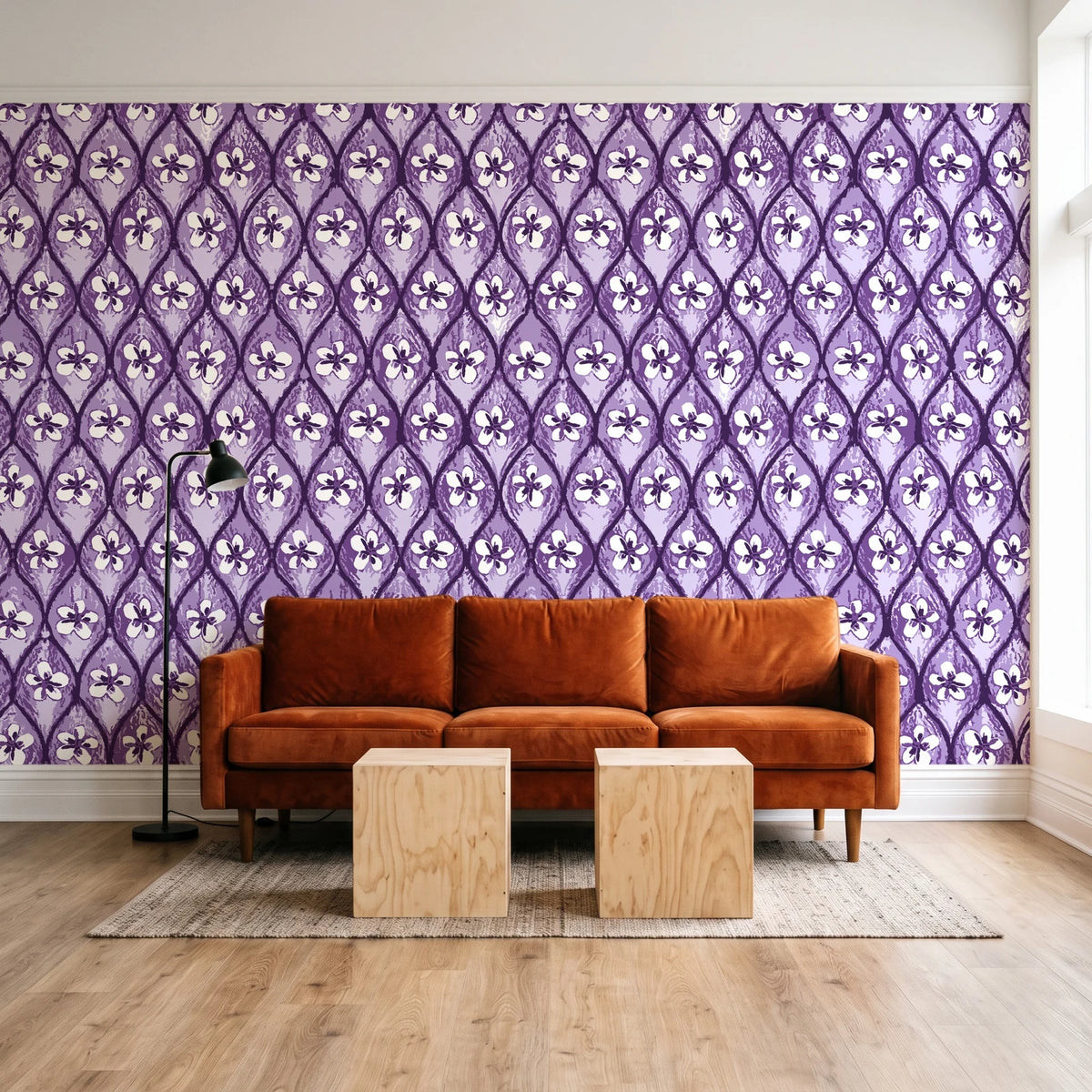 Hidden Court Plum floral ogee wallpaper behind a rust velvet sofa in a bright coworking lounge