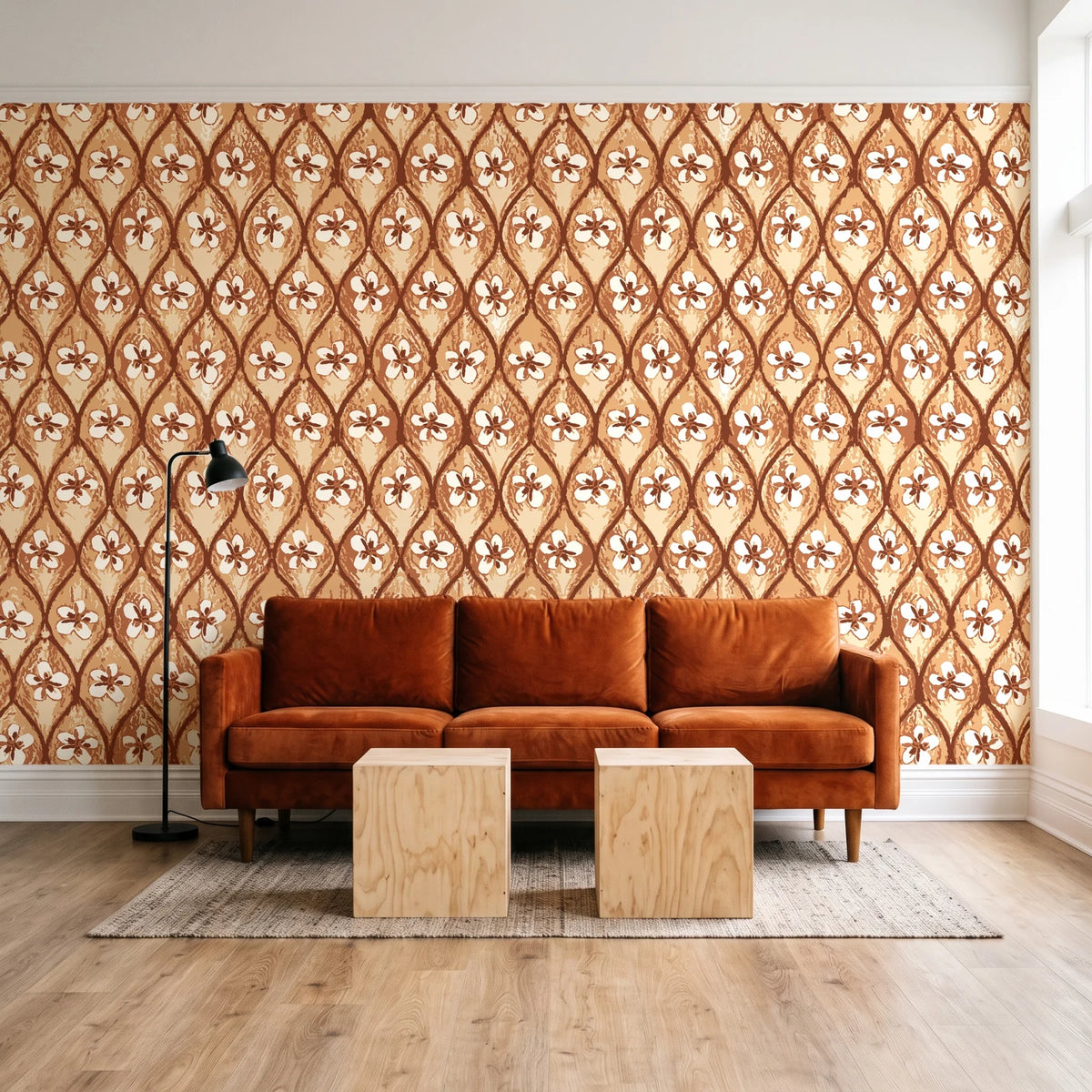 Hidden Court Terracotta floral ogee wallpaper behind a rust velvet sofa in a bright coworking lounge