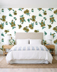 Hidden Garden Emerald floral wallpaper behind a queen bed in a bright coastal bedroom