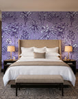 Hush & Palm Plum palm trees wallpaper behind the headboard of a king bed in a contemporary hotel guest room