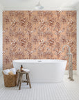 Hush & Palm Terracotta palm trees wallpaper behind a freestanding tub in a bright coastal bathroom