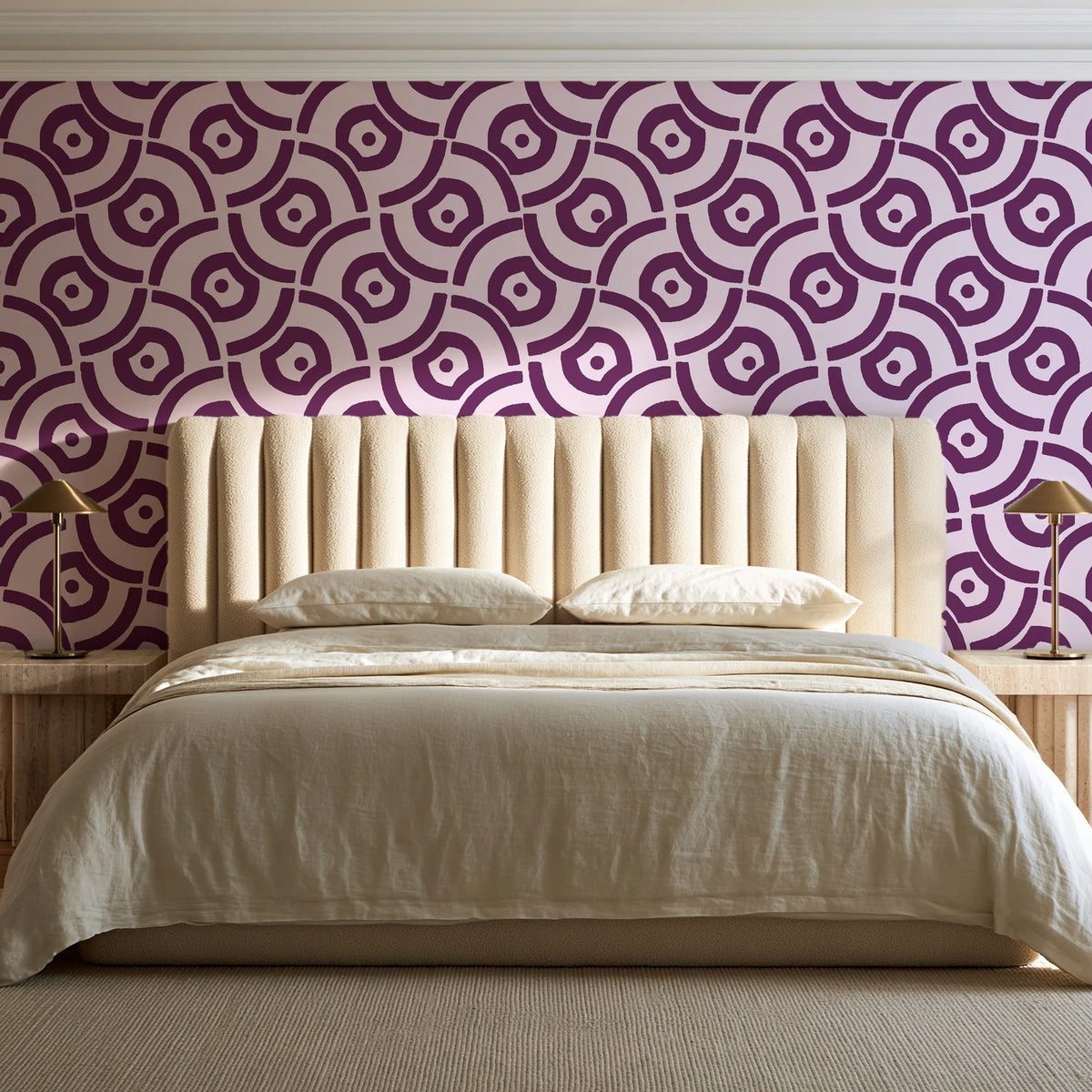 Indigo Labyrinth Plum geometric wallpaper behind a channel-tufted bed in a calm primary bedroom