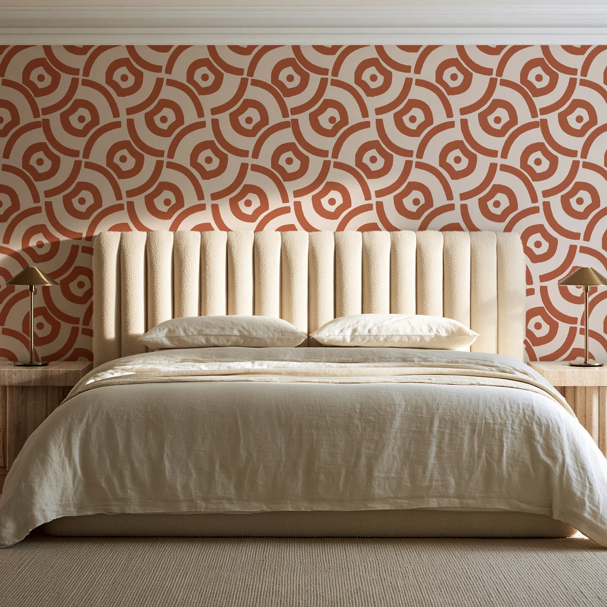 Indigo Labyrinth Terracotta geometric wallpaper behind a channel-tufted bed in a calm primary bedroom