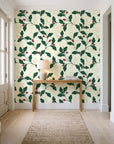 Ink & Oak Evergreen oak leaf and berry wallpaper behind a console table in a light entry hallway