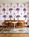 Ink & Shell Aubergine coastal palm and shell wallpaper in a mid-century dining room with a teak sideboard and tulip table