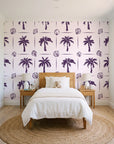 Ink & Shell Aubergine coastal palm and shell wallpaper in a bright, cheerful child's bedroom