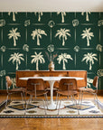 Ink & Shell Forest coastal palm and shell wallpaper in a mid-century dining room with a teak sideboard and tulip table