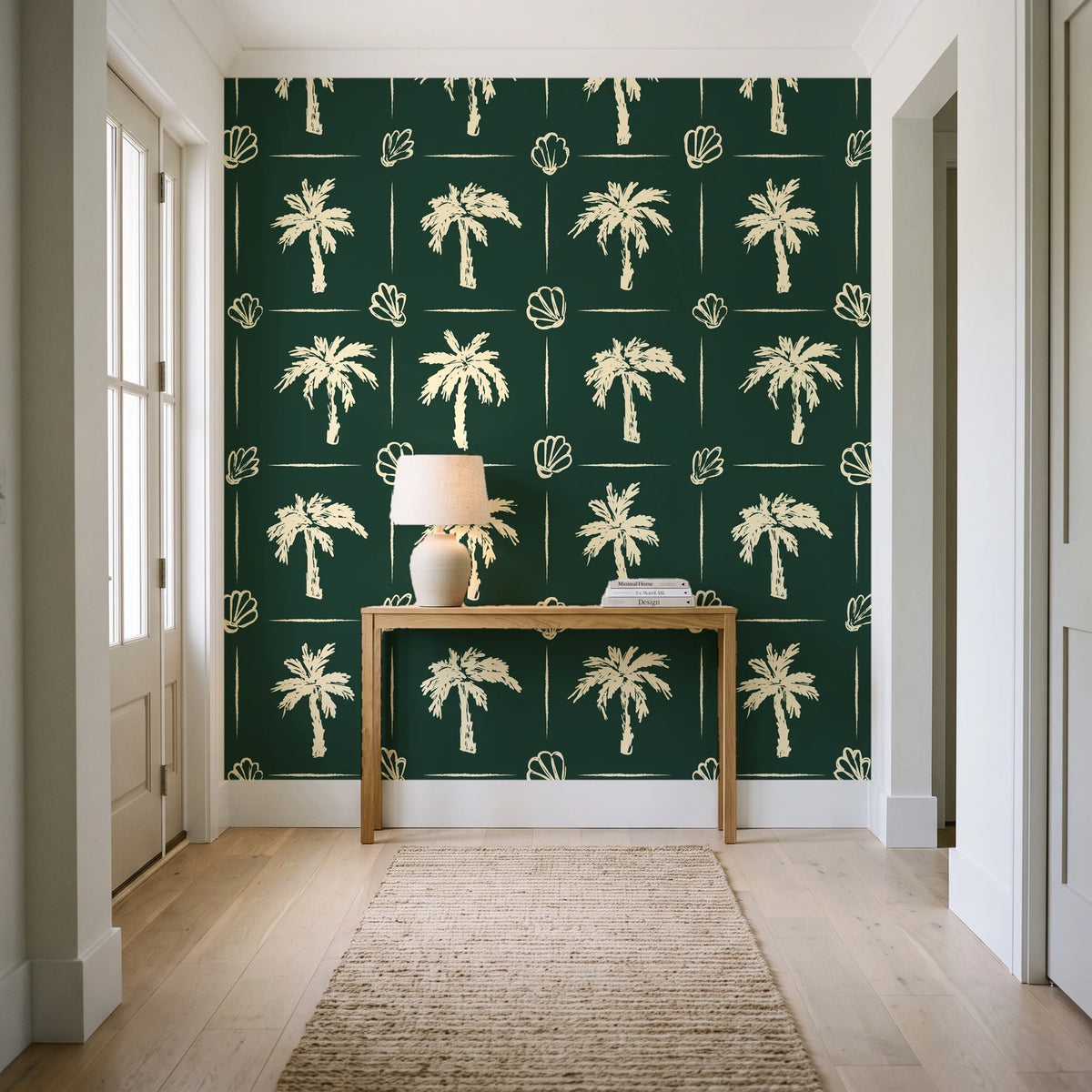 Ink & Shell Forest coastal palm and shell wallpaper behind a console table in a light entry hallway
