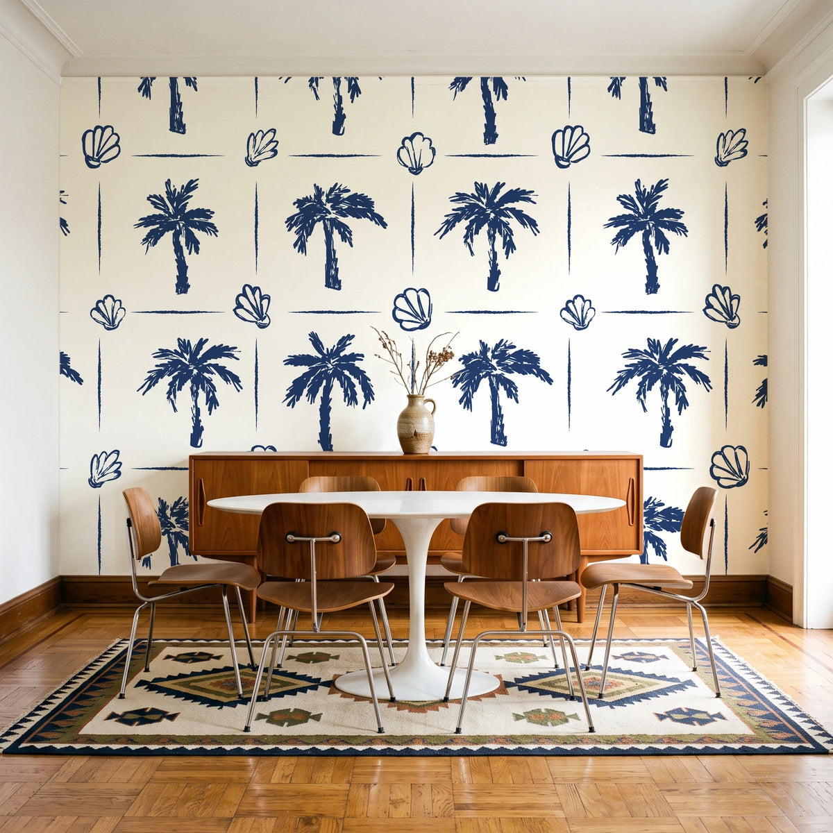 Ink & Shell Navy coastal palm and shell wallpaper in a mid-century dining room with a teak sideboard and tulip table