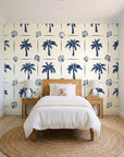 Ink & Shell Navy coastal palm and shell wallpaper in a bright, cheerful child's bedroom