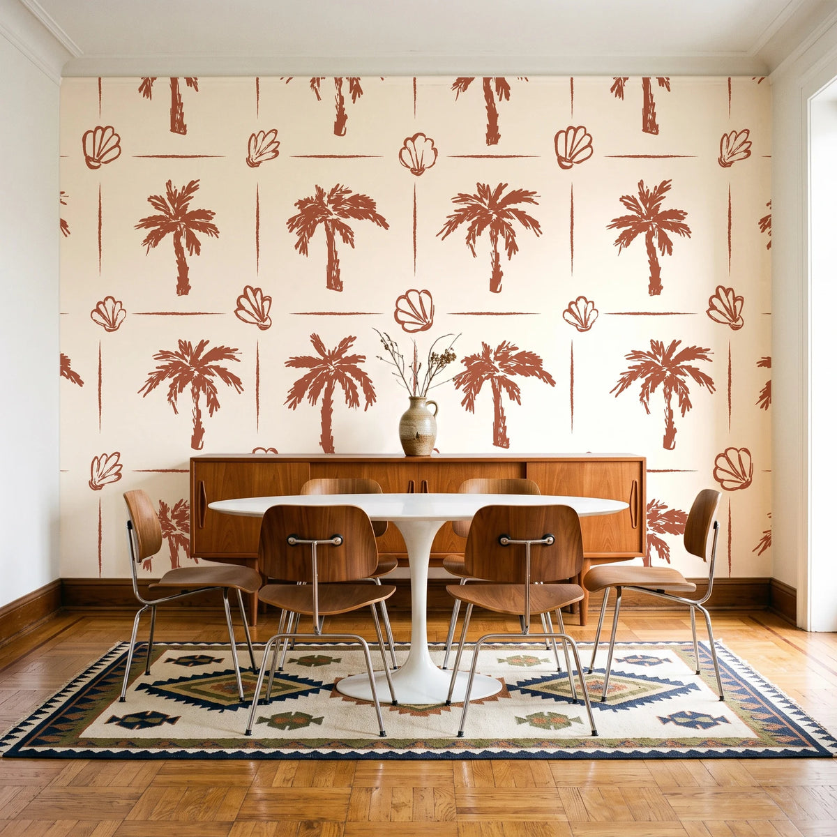 Ink & Shell Terracotta coastal palm and shell wallpaper in a mid-century dining room with a teak sideboard and tulip table