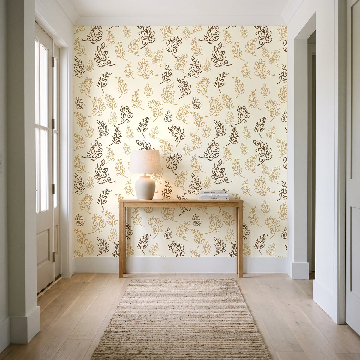 Ink & Sprig Bronze botanical sprig wallpaper behind a console table in a light entry hallway