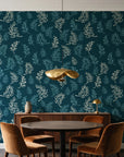 Ink & Sprig Peacock botanical sprig wallpaper behind a walnut credenza and round table in an elegant dining room