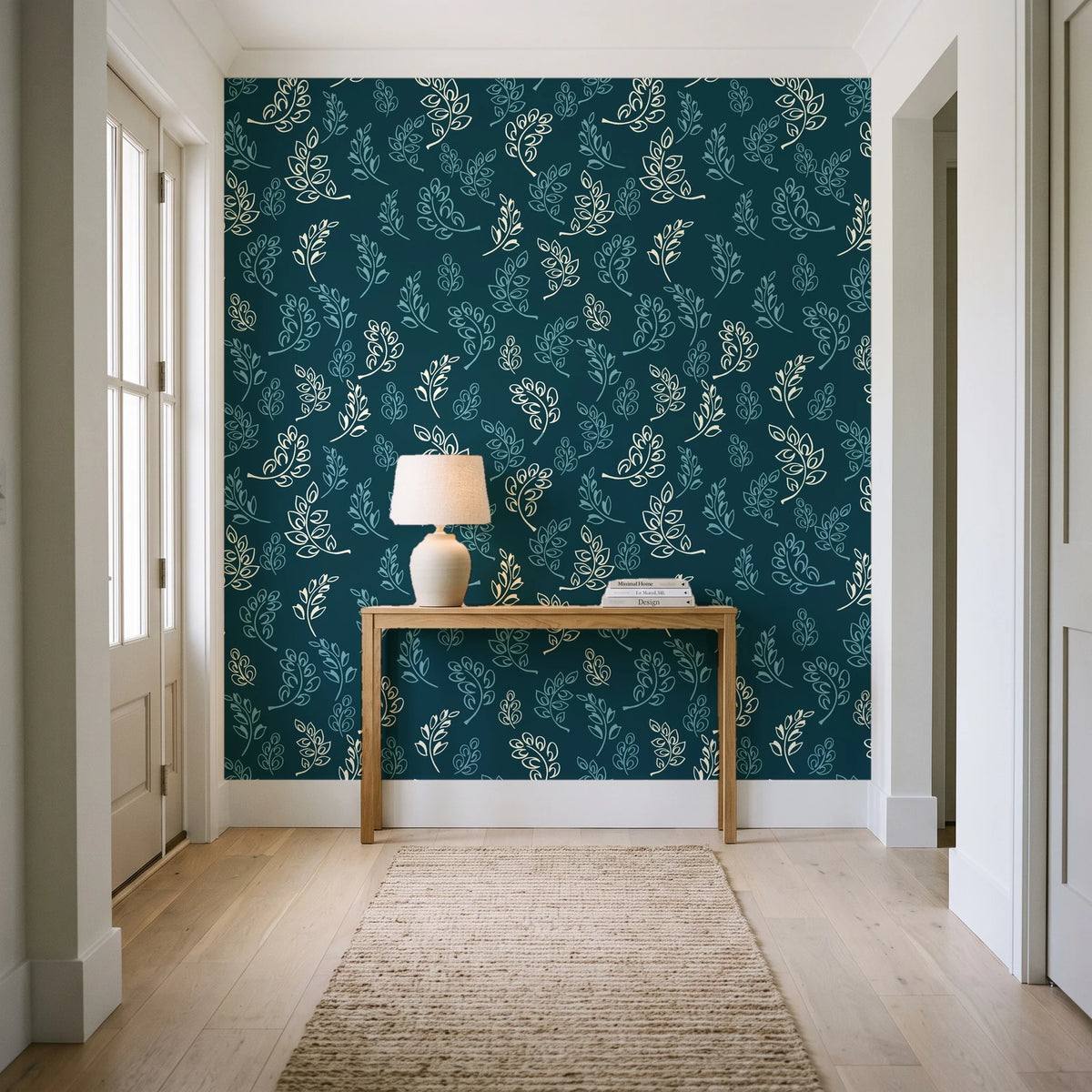 Ink & Sprig Peacock botanical sprig wallpaper behind a console table in a light entry hallway